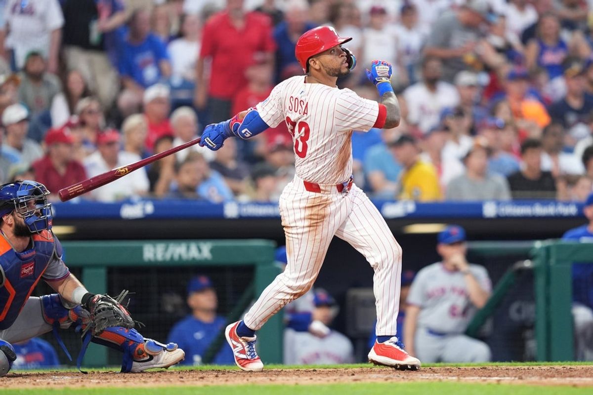 Jun 22, 2025; Philadelphia, Pennsylvania, USA; Philadelphia Phillies infielder Edmundo Sosa (33) hits a three-run home run against the New York Mets in the fourth inning at Citizens Bank Park. Mandatory Credit: Kyle Ross-Imagn Images