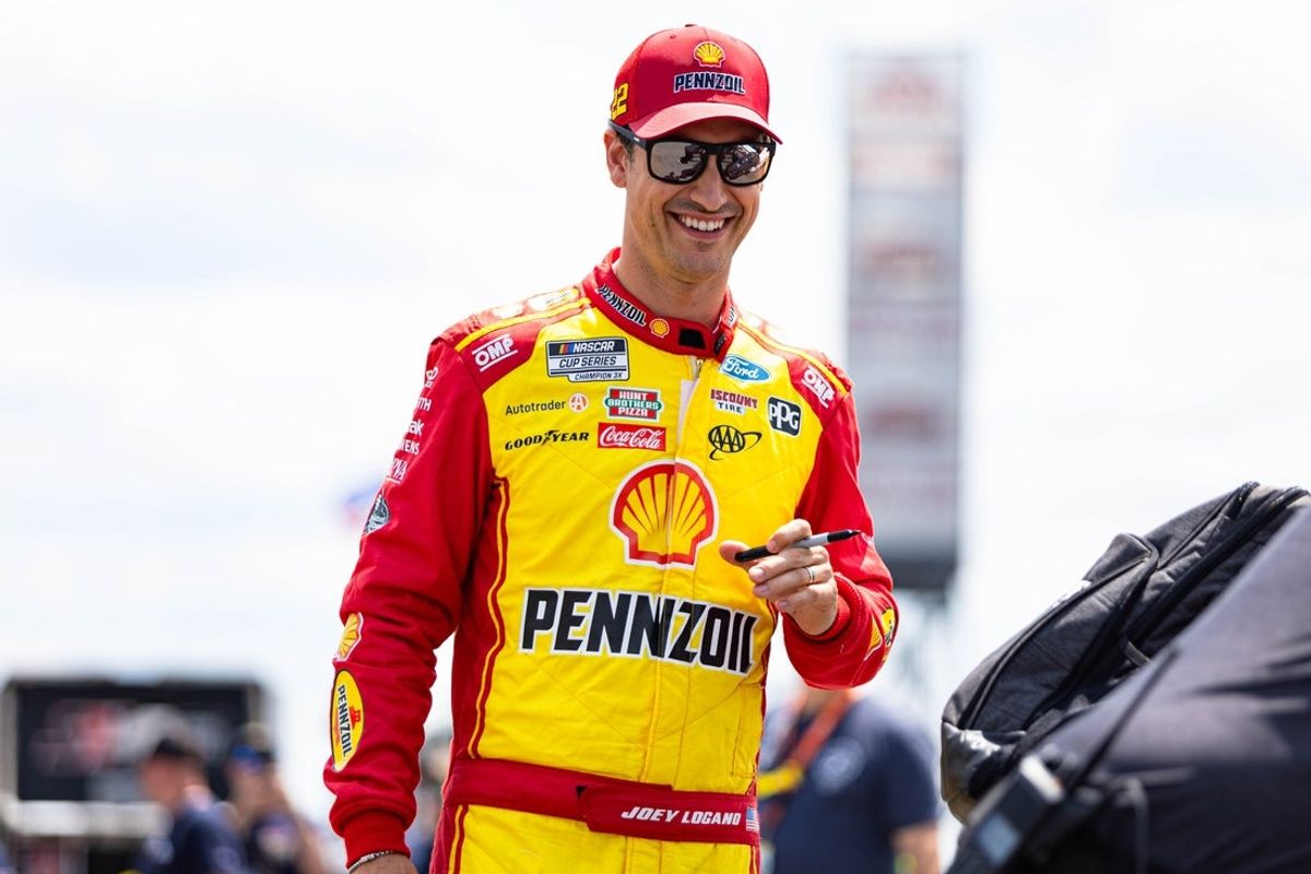 Joey Logano gives out autographs at The Great American Getaway 400 at Pocono Raceway on June 21, 2025.
