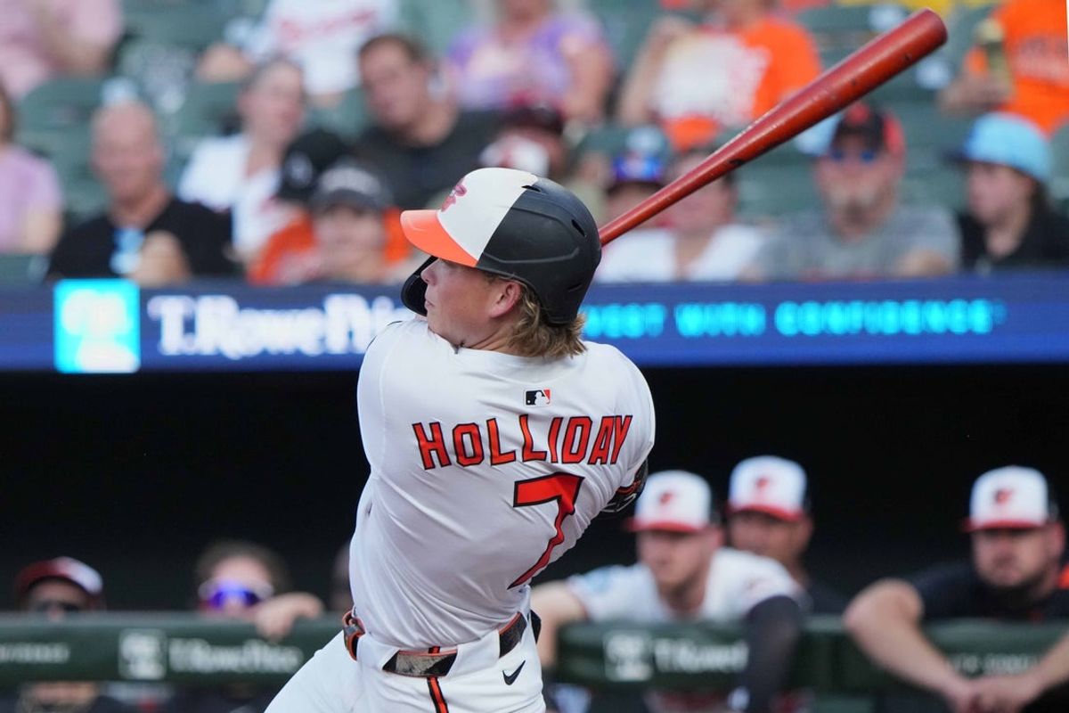 Jun 23, 2025; Baltimore, Maryland, USA; Baltimore Orioles second baseman Jackson Holliday (7) drives in a run with his third inning double against the Texas Rangers at Oriole Park at Camden Yards. Mandatory Credit: Mitch Stringer-Imagn Images