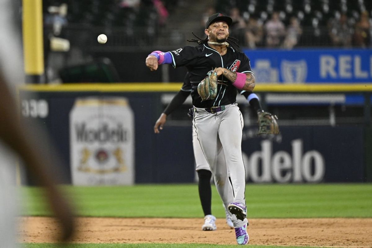 Jun 23, 2025; Chicago, Illinois, USA;  Arizona Diamondbacks second baseman Ketel Marte (4) tries to throw out Chicago White Sox outfielder Luis Robert Jr. (88) at first base during the ninth inning  at Rate Field. Mandatory Credit: Matt Marton-Imagn Images