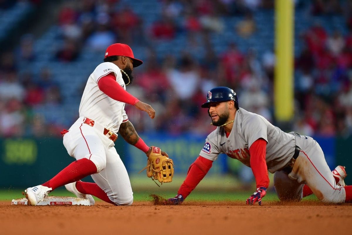 Jun 23, 2025; Anaheim, California, USA; Boston Red Sox first baseman Abraham Toro (29) is tagged out at second by Los Angeles Angels third baseman Luis Rengifo (2) during the fifth inning at Angel Stadium. Mandatory Credit: Gary A. Vasquez-Imagn Images