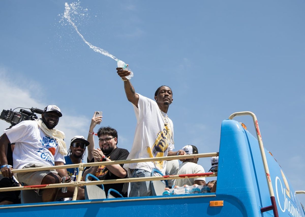 Jun 24, 2025; Oklahoma City, OK, USA;  Oklahoma City Thunder player Jalen Williams splashes water on fans during the 2025 NBA Oklahoma City Thunder championship parade. Mandatory Credit: Brett Rojo-Imagn Images