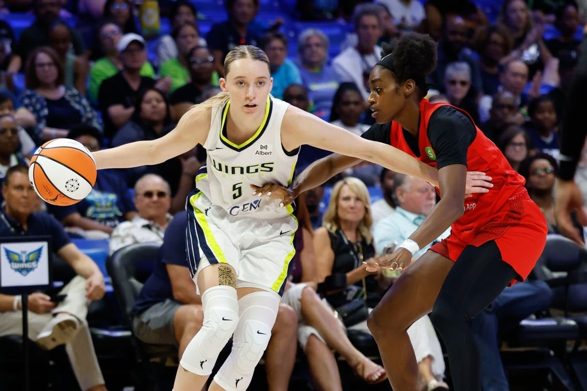 Jun 24, 2025; Arlington, Texas, USA; Dallas Wings guard Paige Bueckers (5) controls the ball as Atlanta Dream guard Maya Caldwell (33) defends during the first half at College Park Center. Mandatory Credit: Chris Jones-Imagn Images