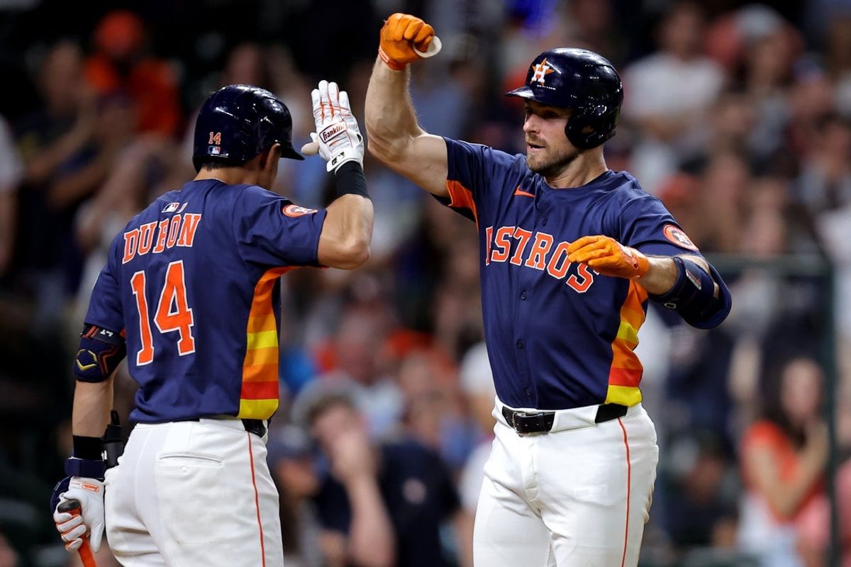 Jun 24, 2025; Houston, Texas, USA; Houston Astros left fielder Cooper Hummel (16) is congratulated by Houston Astros second baseman Mauricio Dubon (14) after hitting a home run to right field against the Philadelphia Phillies during the eighth inning at Daikin Park. Mandatory Credit: Erik Williams-Imagn Images