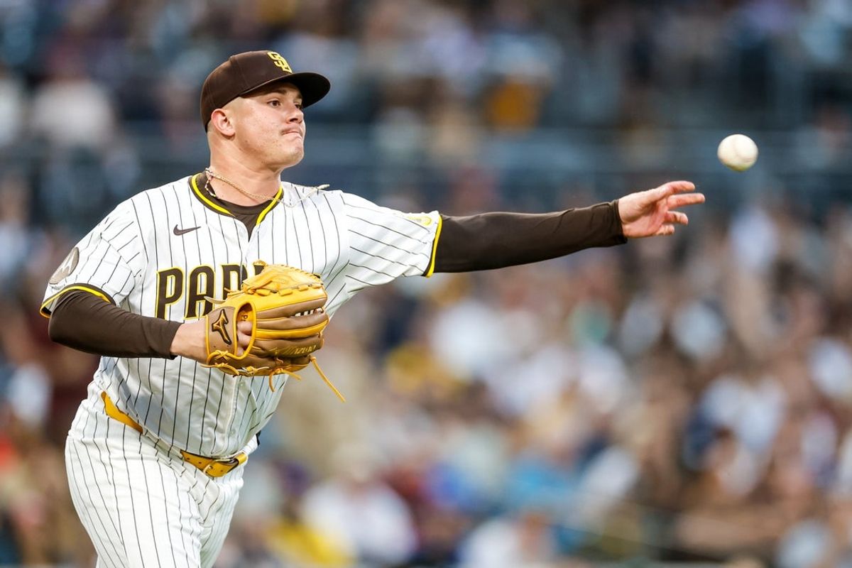 Jun 24, 2025; San Diego, California, USA; San Diego Padres relief pitcher Adrian Morejon (50) makes the throw to first base for an out during the fourth inning against the Washington Nationals at Petco Park. Mandatory Credit: David Frerker-Imagn Images