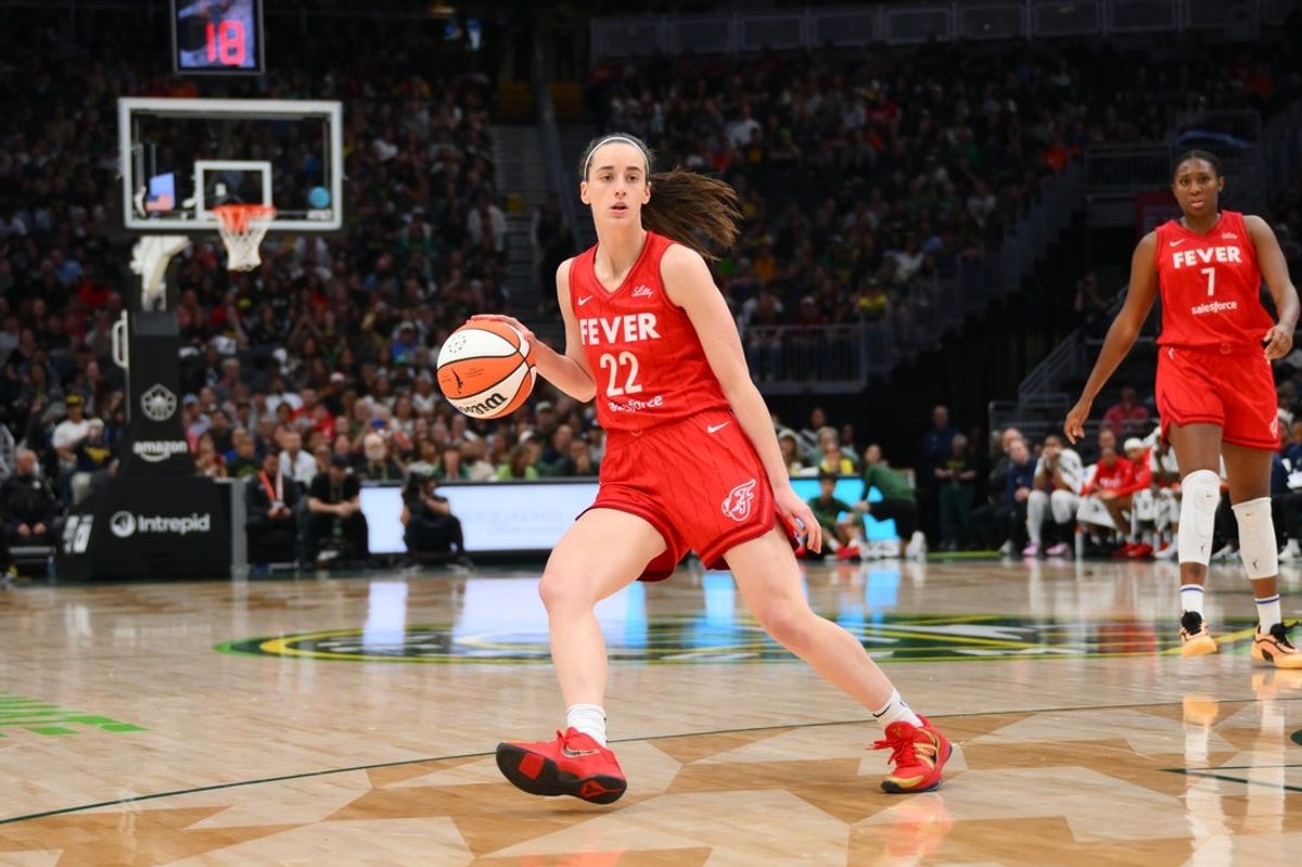 Jun 24, 2025; Seattle, Washington, USA; Indiana Fever guard Caitlin Clark (22) dribbles the ball against the Seattle Storm during the second half at Climate Pledge Arena. Mandatory Credit: Steven Bisig-Imagn Images
