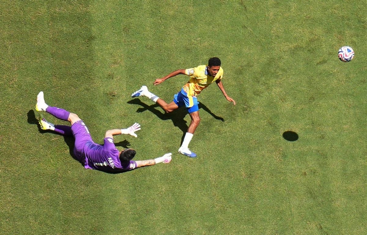 [Subscription Customers Only] Jun 25, 2025; Miami Gardens, Florida, USA; Mamelodi Sundowns FC forward Tashreeq Matthews (17) in action with Fluminense FC goalkeeper Fabio (1) during a group stage match of the 2025 FIFA Club World Cup at Hard Rock Stadium. Mandatory Credit: Marco Bello-Reuters via Imagn Images