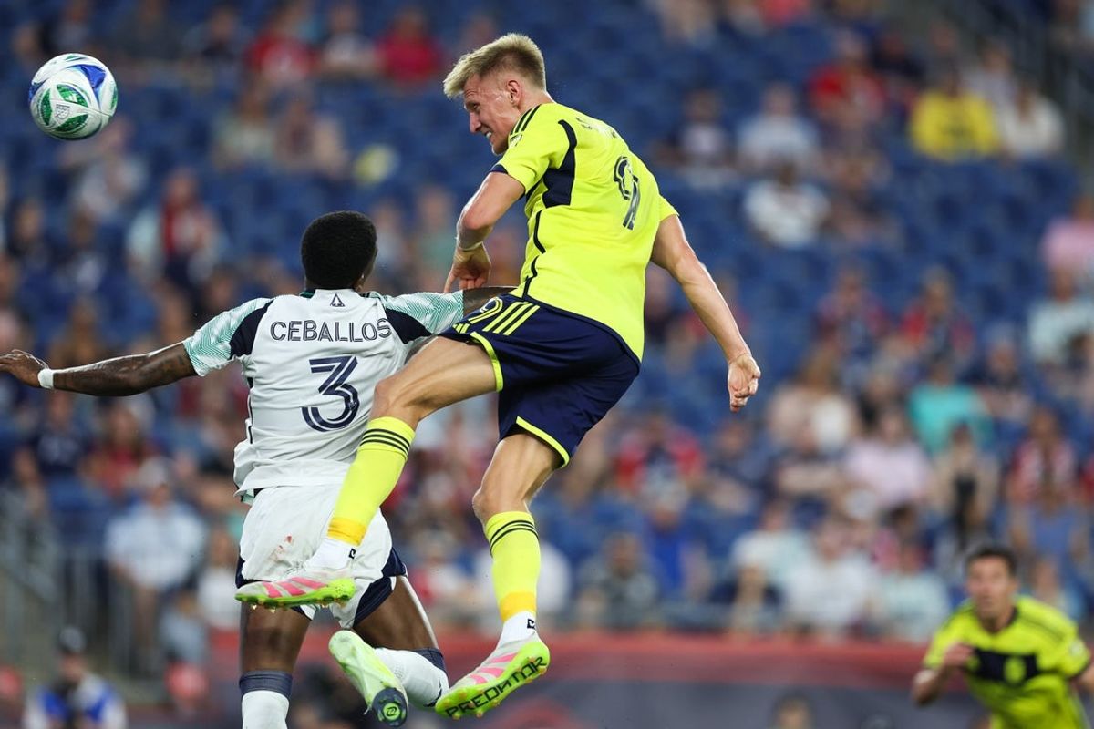 Jun 25, 2025; Foxborough, Massachusetts, USA; Nashville SC forward Sam Surridge (9) heads the ball for a goal during the first half against the New England Revolution at Gillette Stadium. Mandatory Credit: Paul Rutherford-Imagn Images