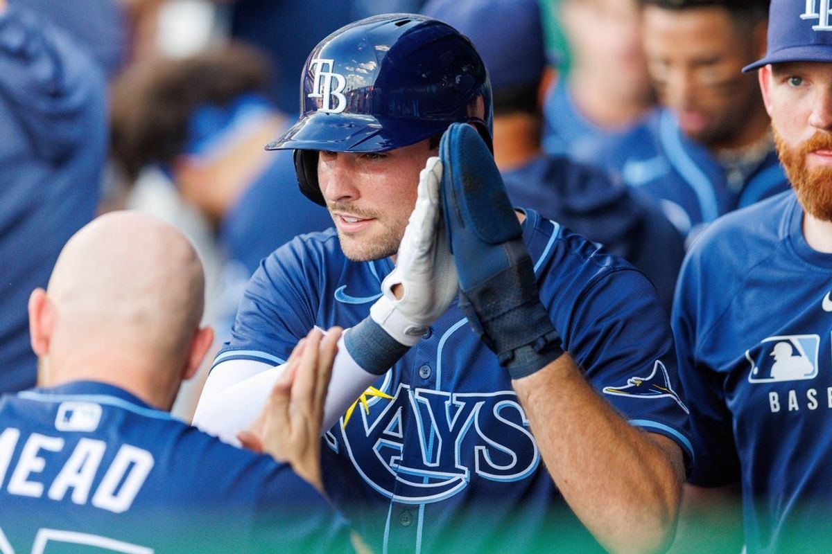 Jun 25, 2025; Kansas City, Missouri, USA; Tampa Bay Rays outfielder Josh Lowe (15) celebrates in the dugout after scoring during the second inning against the Kansas City Royals at Kauffman Stadium. Mandatory Credit: William Purnell-Imagn Images