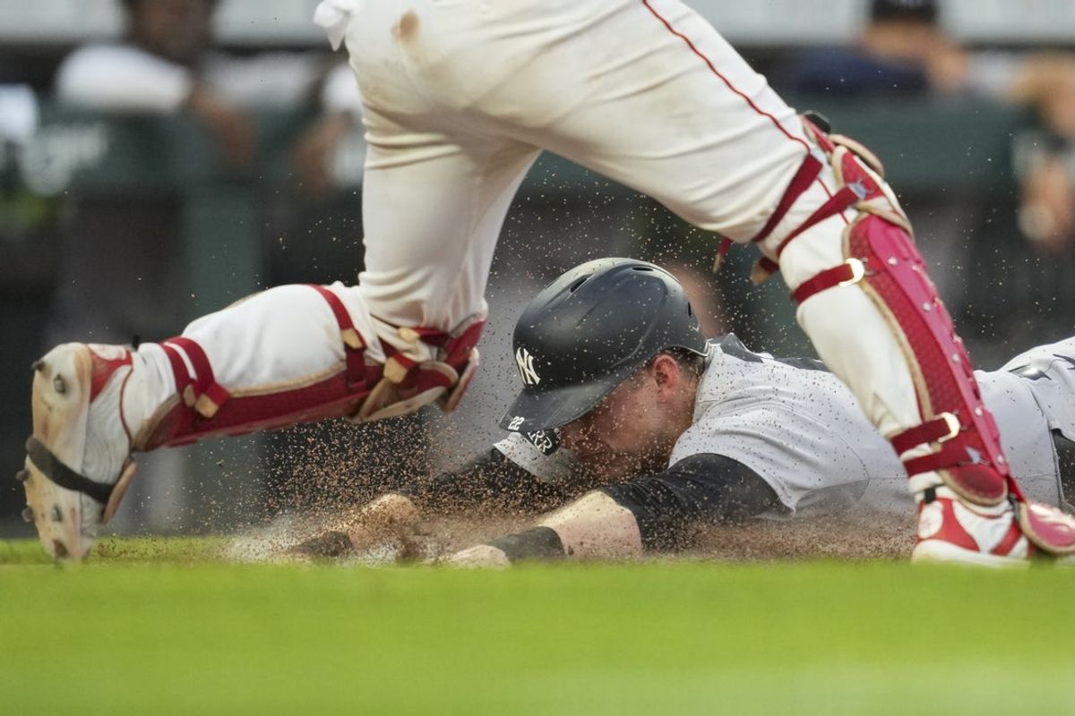 Jun 25, 2025; Cincinnati, Ohio, USA; New York Yankees first baseman Ben Rice scores a run ahead of the tag from Cincinnati Reds catcher Jose Trevino in the fifth inning at Great American Ball Park. Mandatory Credit: Aaron Doster-Imagn Images