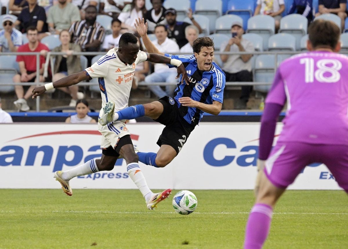 Jun 25, 2025; Montreal, Province of Quebec, CAN; FC Cincinnati midfielder Obinna Nwobodo (5) pushes CF Montreal midfielder Caden Clark (23) during the first half at Saputo Stadium. Mandatory Credit: Eric Bolte-Imagn Images