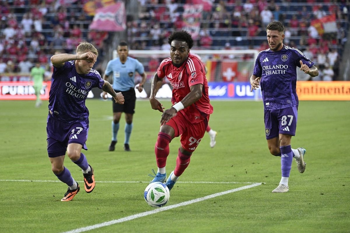 Jun 25, 2025; St. Louis, Missouri, USA; Orlando City midfielder Dagur Thorhallsson (17) and forward Marco Pasalic (87) defend against St. Louis CITY SC forward Jayden Reid (99) in the first half at Energizer Park. Mandatory Credit: Joe Puetz-Imagn Images