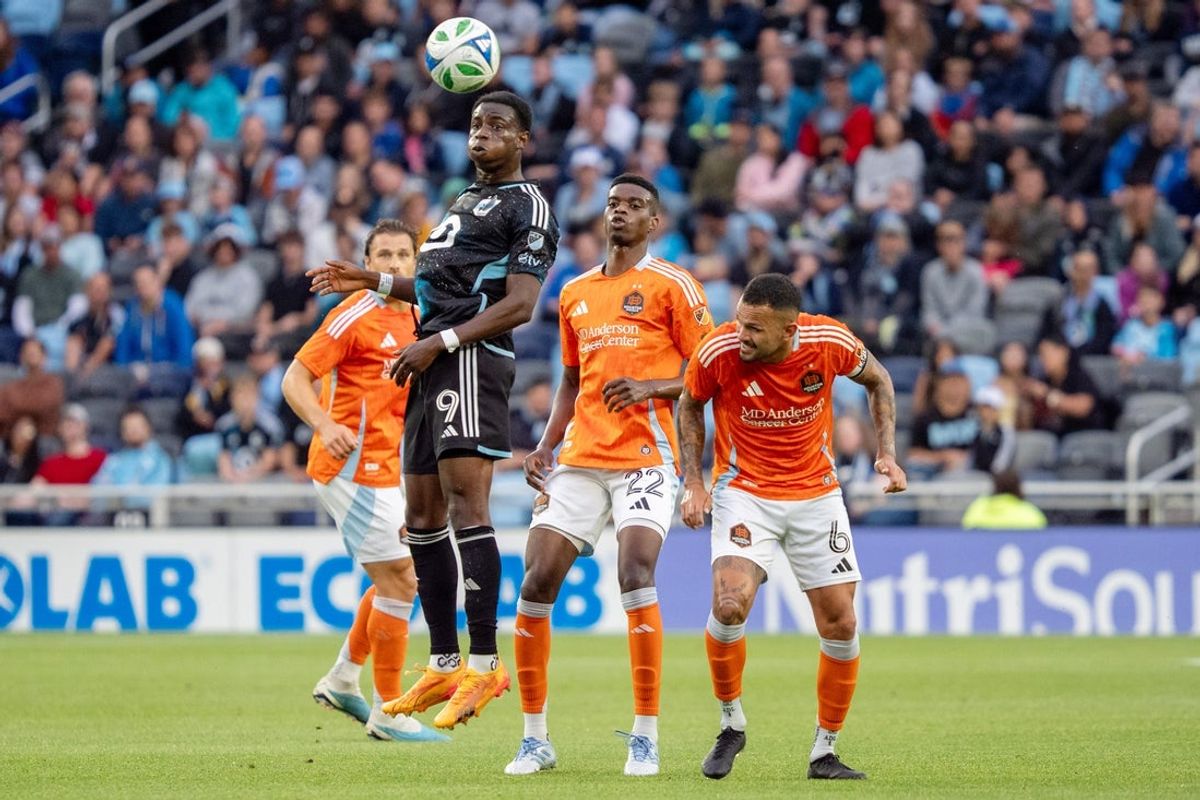 Jun 25, 2025; Saint Paul, Minnesota, USA; Minnesota United forward Kelvin Yeboah (9) plays a ball off his head in front of Houston Dynamo FC defender Pablo Ortiz (22) and Houston Dynamo FC midfielder Artur (6) in the first half at Allianz Field. Mandatory Credit: Matt Blewett-Imagn Images