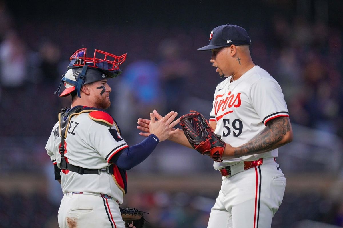 Jun 25, 2025; Minneapolis, Minnesota, USA; Minnesota Twins pitcher Jhoan Duran (59) and catcher Christian Vazquez (8) celebrate after the game against the Seattle Mariners at Target Field. Mandatory Credit: Brad Rempel-Imagn Images