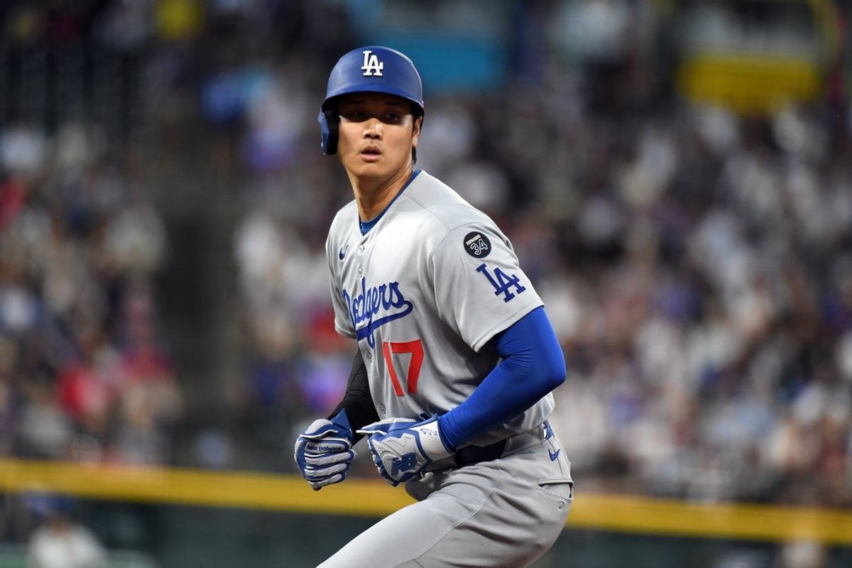 Jun 25, 2025; Denver, Colorado, USA; Los Angeles Dodgers two-way player Shohei Ohtani (17) at first base after singling during the sixth inning against the Colorado Rockies at Coors Field. Mandatory Credit: Christopher Hanewinckel-Imagn Images