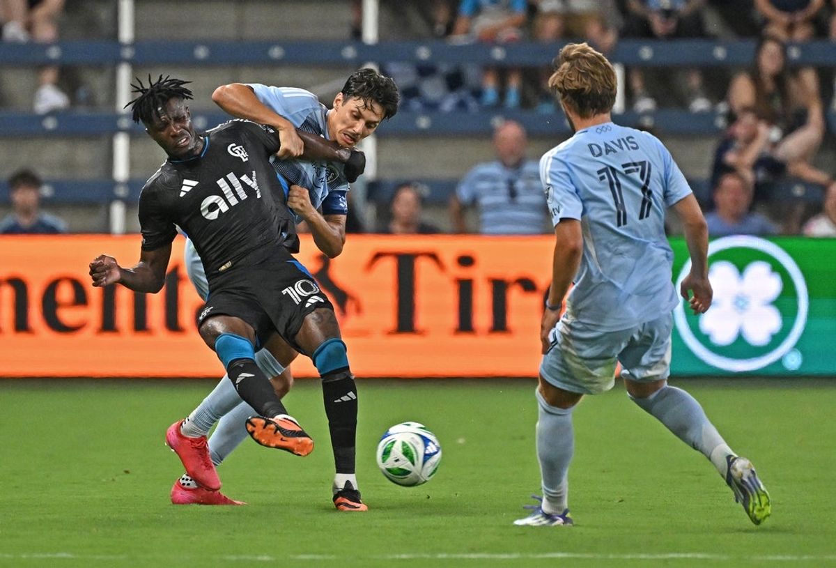 Jun 25, 2025; Kansas City, Kansas, USA;  Charlotte FC forward Wilfried Zaha (10) and Sporting Kansas City forward Daniel Salloi (10) battle for the ball in the second half at Children's Mercy Park. Mandatory Credit: Peter Aiken-Imagn Images