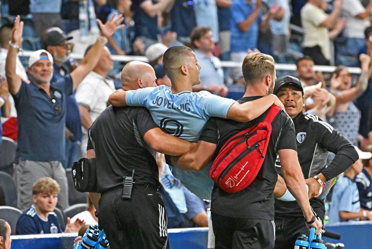Jun 25, 2025; Kansas City, Kansas, USA;  Sporting Kansas City forward Dejan Joveljic (9) is carried off the field after getting injured scoring the go ahead goal in the second half against Charlotte FC at Children's Mercy Park. Mandatory Credit: Peter Aiken-Imagn Images