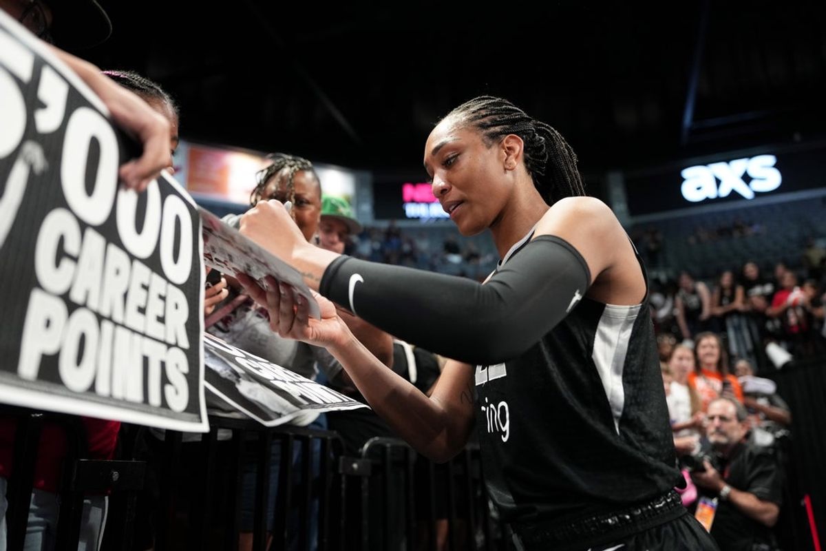 Jun 25, 2025; Las Vegas, Nevada, USA; Las Vegas Aces center A'ja Wilson (22) signs autographs for fans after an WNBA basketball game against the Connecticut Sun at Michelob Ultra Arena. Mandatory Credit: Lucas Peltier-Imagn Images
