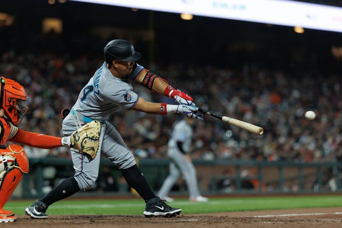 Jun 25, 2025; San Francisco, California, USA; Miami Marlins designated hitter Heriberto Hernandez (64) hits a two run RBI single during the eighth inning against the San Francisco Giants at Oracle Park. Mandatory Credit: Sergio Estrada-Imagn Images