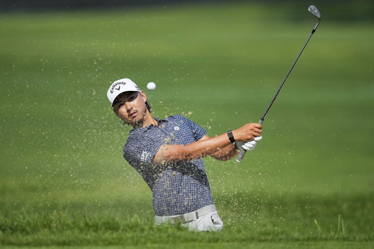 Jun 26, 2025; Detroit, Michigan, USA; Min Woo Lee plays his shot from a bunker on the second green during the first round of the Rocket Mortgage Classic golf tournament. Mandatory Credit: Aaron Doster-Imagn Images