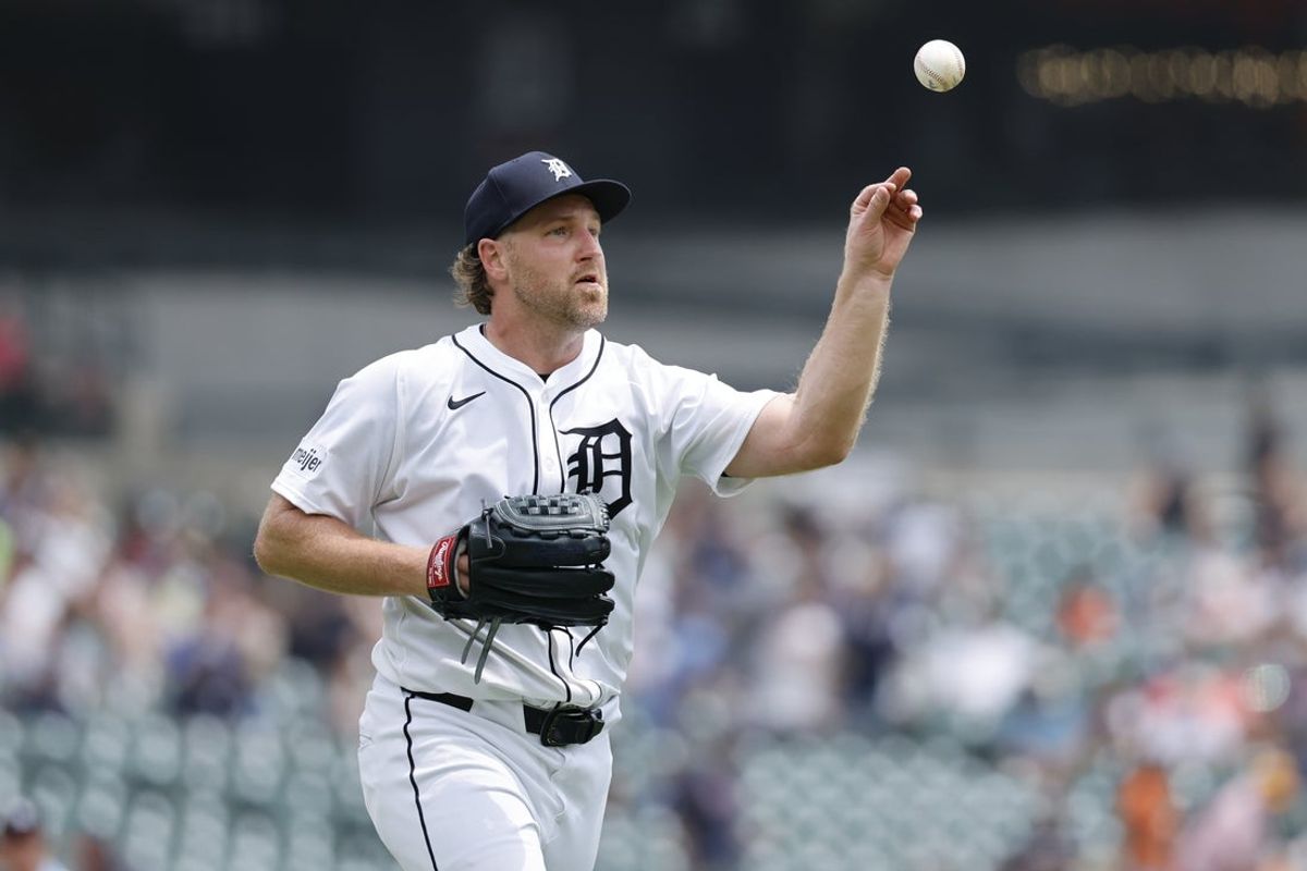 Jun 26, 2025; Detroit, Michigan, USA;  Detroit Tigers pitcher Dietrich Enns (51) makes a throw to first in the first inning against the Athletics at Comerica Park. Mandatory Credit: Rick Osentoski-Imagn Images