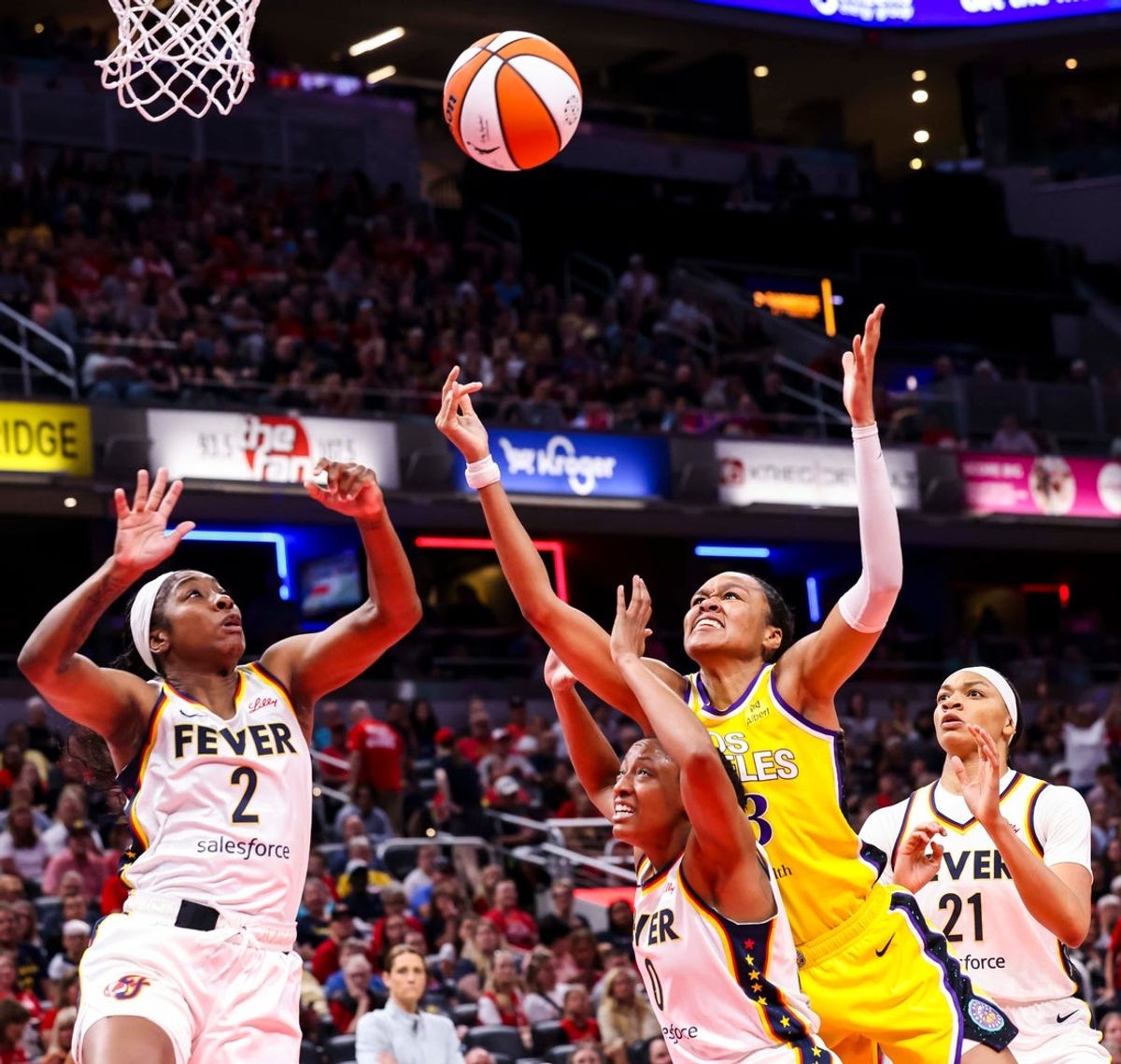 Indiana Fever guard Aari McDonald (2), Indiana Fever guard Kelsey Mitchell (0), Los Angeles Sparks forward Azura Stevens (23) and Indiana Fever forward Makayla Timpson (21) go for the rebound Thursday, June 26, 2025, during a game between the Indiana Fever and the Los Angeles Sparks at Gainbridge Fieldhouse in Indianapolis.