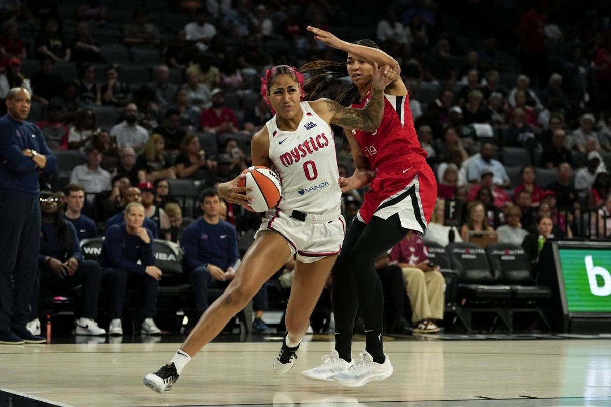 Jun 26, 2025; Las Vegas, Nevada, USA; Washington Mystics forward Shakira Austin (0) drives the ball past Las Vegas Aces center Kiah Stokes (41) during the second half of a WNBA basketball game at Michelob Ultra Arena. Mandatory Credit: Lucas Peltier-Imagn Images