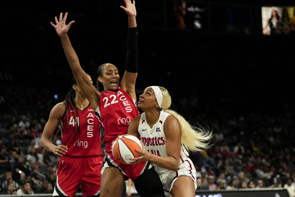 Jun 26, 2025; Las Vegas, Nevada, USA; Washington Mystics forward Kiki Iriafen (44) attempts to score a layup against Las Vegas Aces center A'ja Wilson (22) during the second half of a WNBA basketball game at Michelob Ultra Arena. Mandatory Credit: Lucas Peltier-Imagn Images