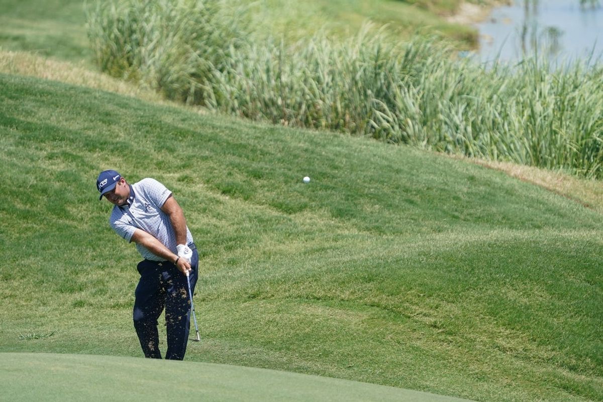 Jun 27, 2025; Carrollton, Texas, USA; Patrick Reed plays a shot on the 15th hole during the first round of the LIV Golf Dallas golf tournament at Maridoe Golf Club. Mandatory Credit: Raymond Carlin III-Imagn Images