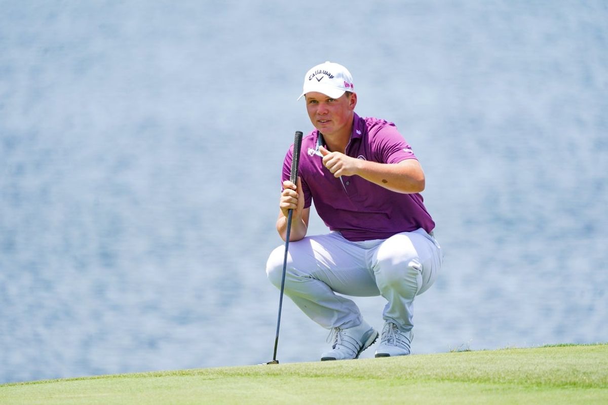 Caleb Surratt gives a thumbs up to teammate Jon Rahm on the 15th green during the first round of the LIV Golf Dallas golf tournament at Maridoe Golf Club. Mandatory Credit: Raymond Carlin III-Imagn Images