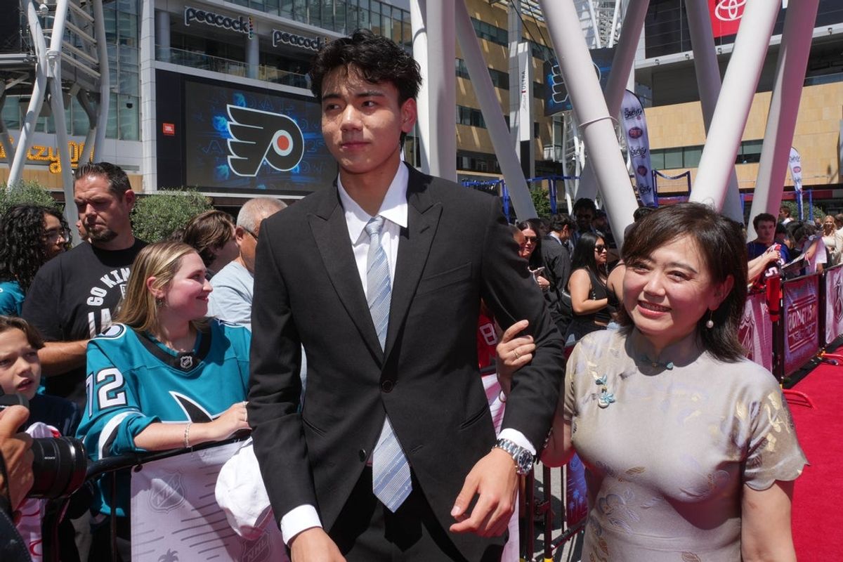 Jun 27, 2025; Los Angeles, California, USA; Simon Wang, with his mother, Willa, arrive to the first round of the 2025 NHL Draft at Peacock Theater. Mandatory Credit: Kirby Lee-Imagn Images
