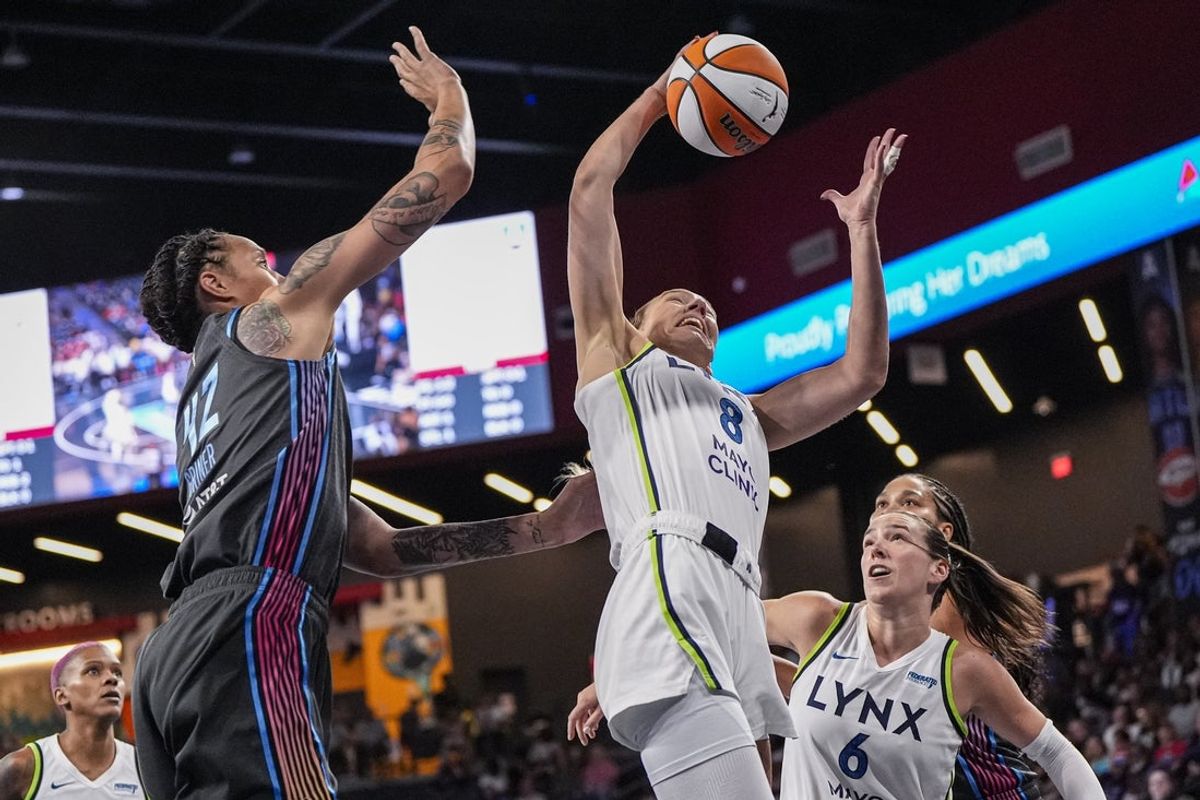 Jun 27, 2025; College Park, Georgia, USA; Minnesota Lynx forward Alanna Smith (8) gets a rebound over Atlanta Dream center Brittney Griner (42) during the first half at Gateway Center Arena at College Park. Mandatory Credit: Dale Zanine-Imagn Images