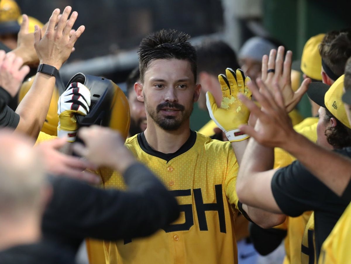 Jun 27, 2025; Pittsburgh, Pennsylvania, USA;  Pittsburgh Pirates right fielder Bryan Reynolds (10) celebrates in the dugout after hitting a three run home run against the New York Mets during the sixth inning at PNC Park. Mandatory Credit: Charles LeClaire-Imagn Images