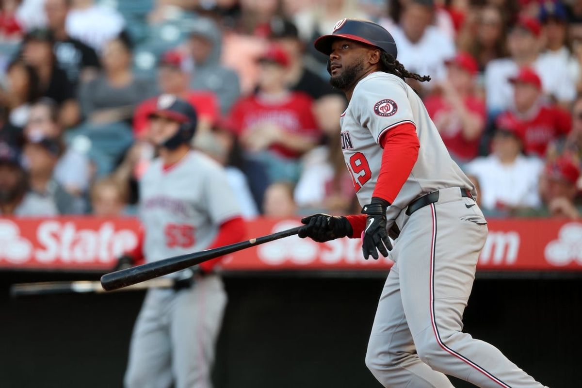 Jun 27, 2025; Anaheim, California, USA; Washington Nationals designated hitter Josh Bell (19) hits a two-run home run during the second inning against the Los Angeles Angels at Angel Stadium. Mandatory Credit: Kiyoshi Mio-Imagn Images
