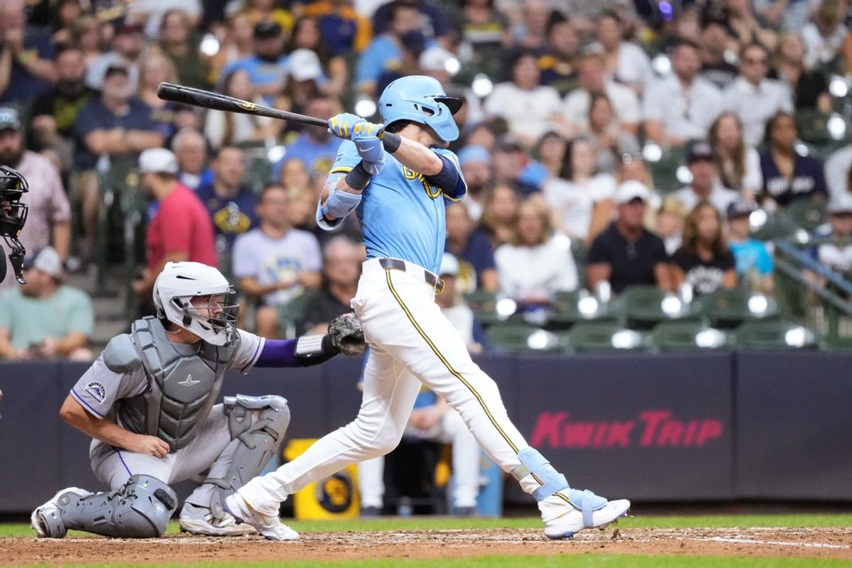 Jun 27, 2025; Milwaukee, Wisconsin, USA;  Milwaukee Brewers designated hitter Christian Yelich (22) hits an RBI double during the eighth inning against the Colorado Rockies at American Family Field. Mandatory Credit: Jeff Hanisch-Imagn Images