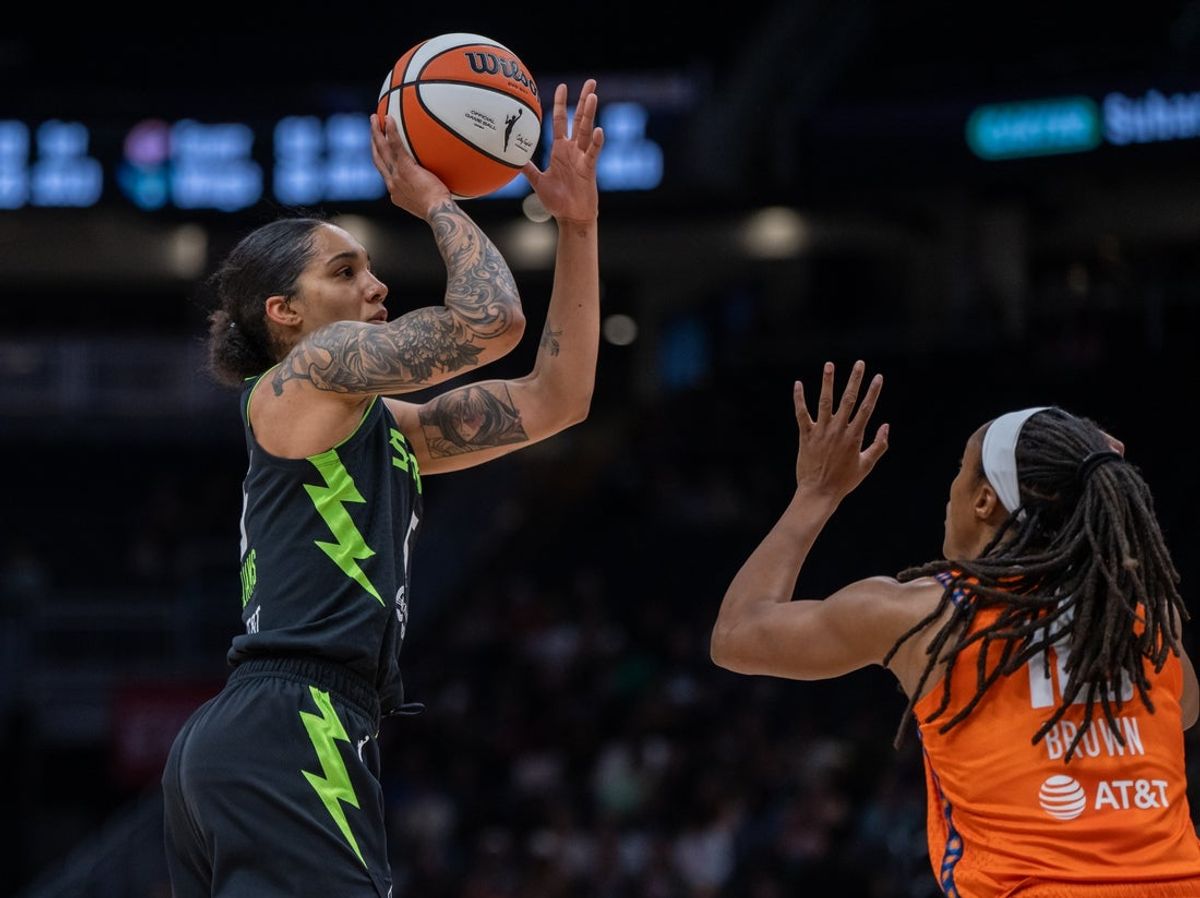 Jun 27, 2025; Seattle, Washington, USA;  Seattle Storm forward Gabby Williams (5) shoots the ball against Connecticut Sun guard Jaelyn Brown (18) during the first half at Climate Pledge Arena. Mandatory Credit: Stephen Brashear-Imagn Images