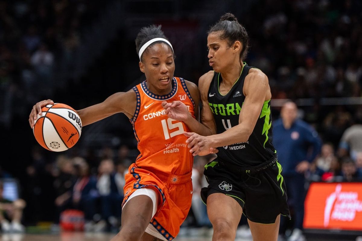 Jun 27, 2025; Seattle, Washington, USA;  Connecticut Sun guard Lindsay Allen (15) dribbles the ball against Seattle Storm guard Skylar Diggins (4) during the second half at Climate Pledge Arena. Mandatory Credit: Stephen Brashear-Imagn Images