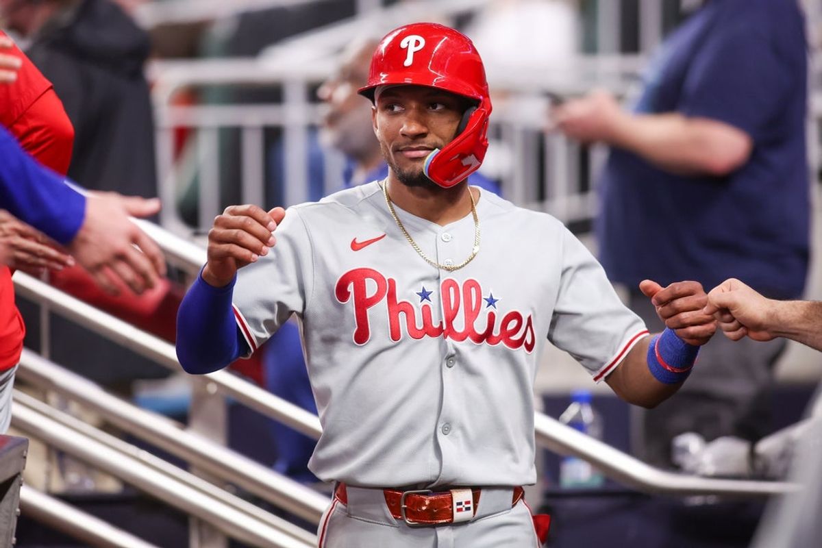 Jun 27, 2025; Atlanta, Georgia, USA; Philadelphia Phillies center fielder Johan Rojas (23) celebrates with teammates after scoring a run against the Atlanta Braves in the ninth inning at Truist Park. Mandatory Credit: Brett Davis-Imagn Images