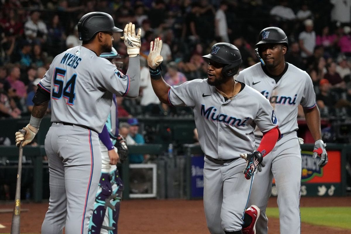 Jun 27, 2025; Phoenix, Arizona, USA; Miami Marlins second base Otto Lopez (6) celebrates with outfielder Dane Myers (54) after hitting a two run home run against the Arizona Diamondbacks in the ninth inning at Chase Field. Mandatory Credit: Rick Scuteri-Imagn Images
