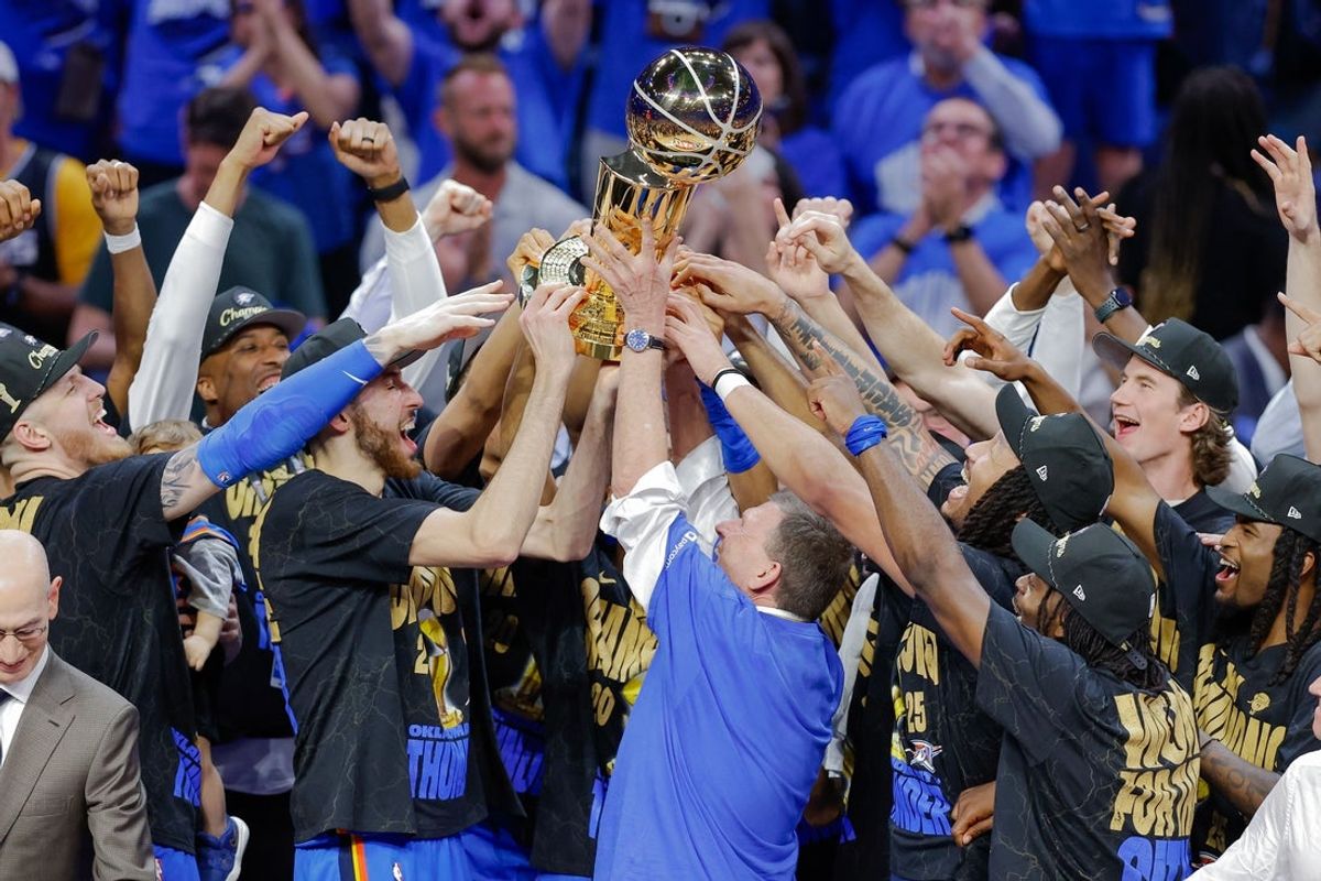 Jun 22, 2025; Oklahoma City, Oklahoma, USA; Oklahoma City Thunder team owner Clay Bennett and the team hold up the Larry O'Brien Championship Trophy after being announced NBA Champions at the end of game seven of the 2025 NBA Finals at Paycom Center. Mandatory Credit: Alonzo Adams-Imagn Images