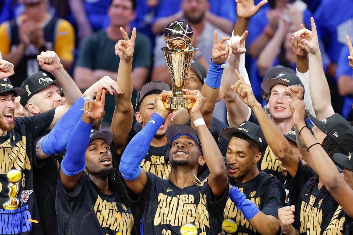 Jun 22, 2025; Oklahoma City, Oklahoma, USA; Oklahoma City Thunder guard Shai Gilgeous-Alexander (2) holds up his NBA Finals Bill Russell MVP trophy at the end of game seven of the 2025 NBA Finals after defeating the Indiana Pacers at Paycom Center. Mandatory Credit: Alonzo Adams-Imagn Images