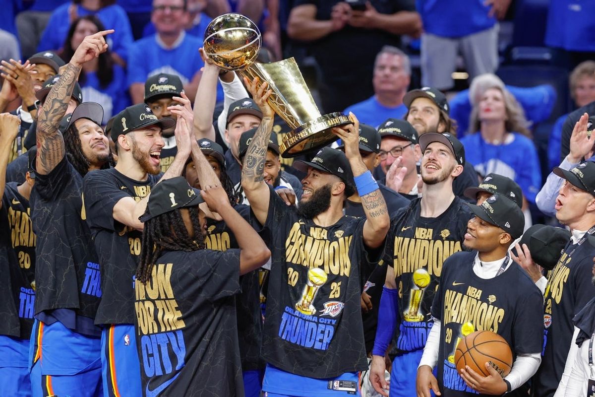 Jun 22, 2025; Oklahoma City, Oklahoma, USA; Oklahoma City Thunder forward Kenrich Williams (34) holds up the NBA Finals Larry O'Brien Championship Trophy after his team defeated the Indiana Pacers in game seven of the 2025 NBA Finals at Paycom Center. Mandatory Credit: Alonzo Adams-Imagn Images