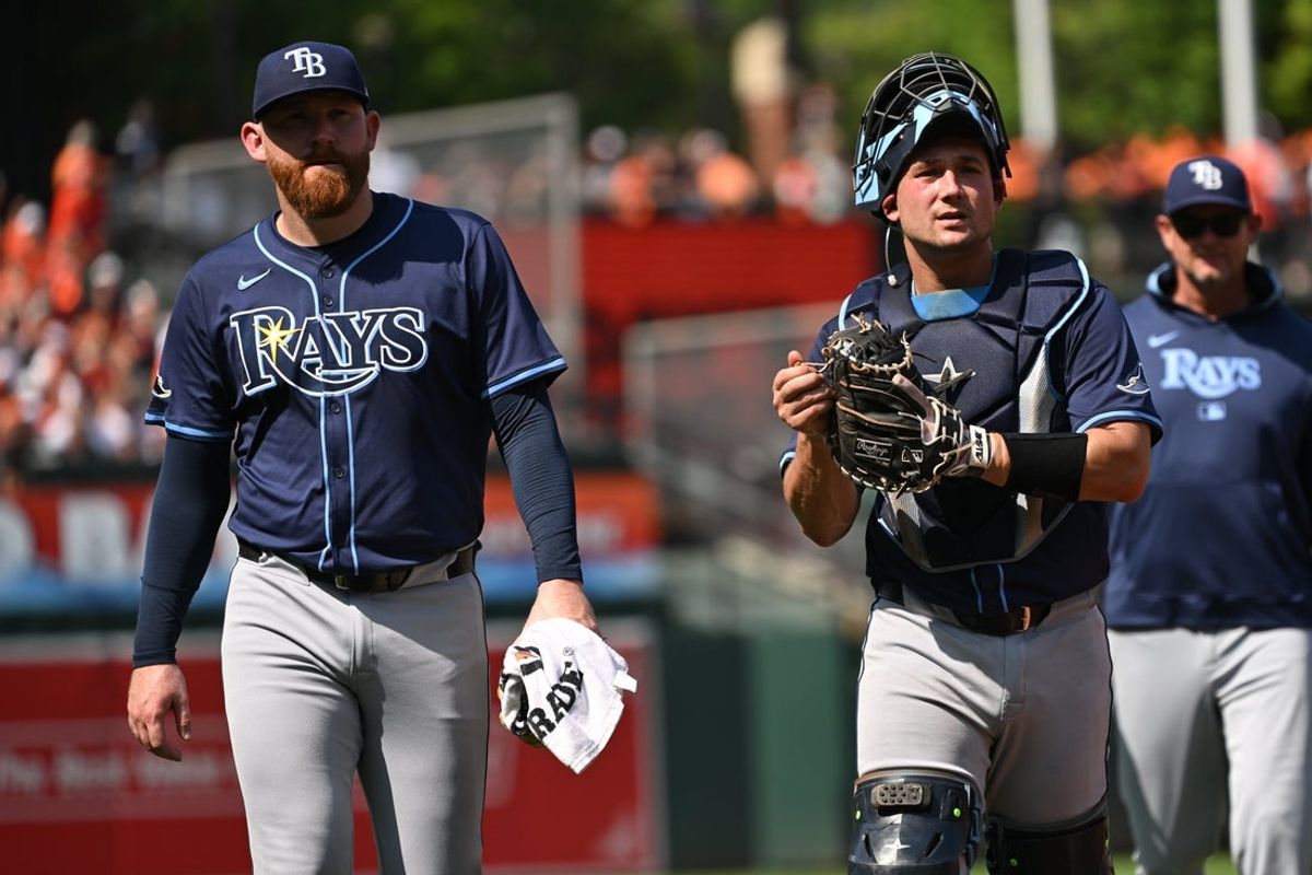 Jun 28, 2025; Baltimore, Maryland, USA; Tampa Bay Rays starting pitcher Zack Littell (52) and catcher Matt Thaiss (34) walk to the dugout before a game against the Baltimore Orioles at Oriole Park at Camden Yards. Mandatory Credit: Rafael Suanes-Imagn Images