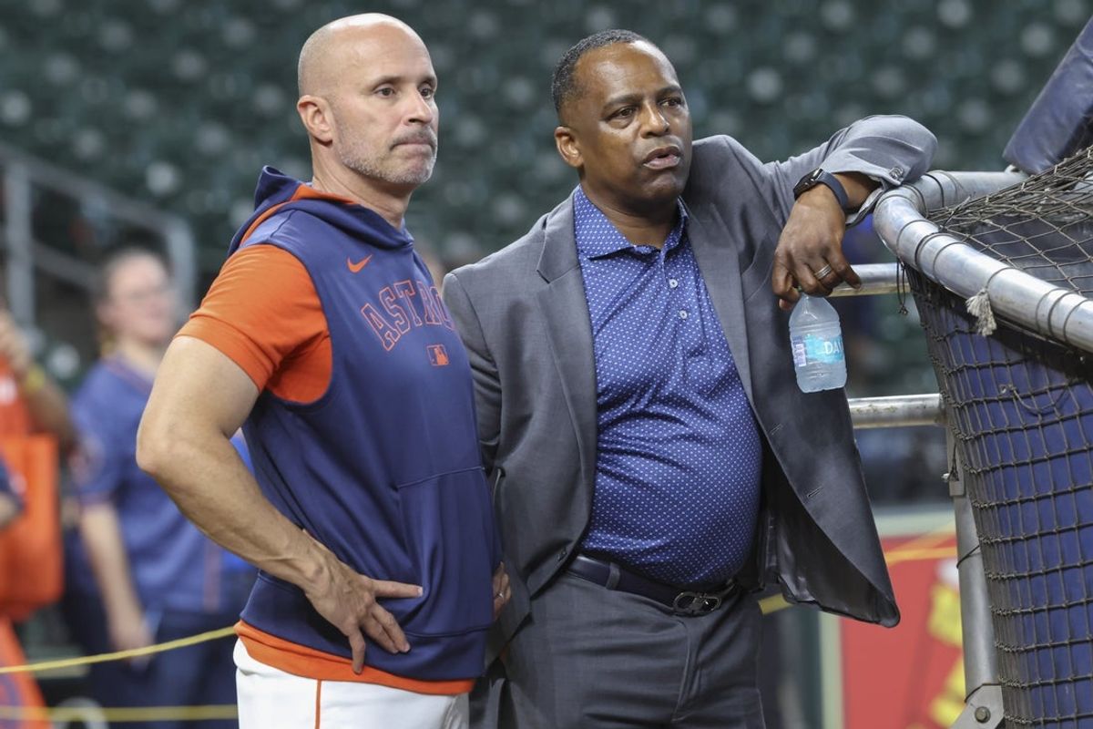 Jun 28, 2025; Houston, Texas, USA; Houston Astros manager Joe Espada (left) and general manager Dana Brown (right) talk on the field before the game against the Chicago Cubs at Daikin Park. Mandatory Credit: Troy Taormina-Imagn Images