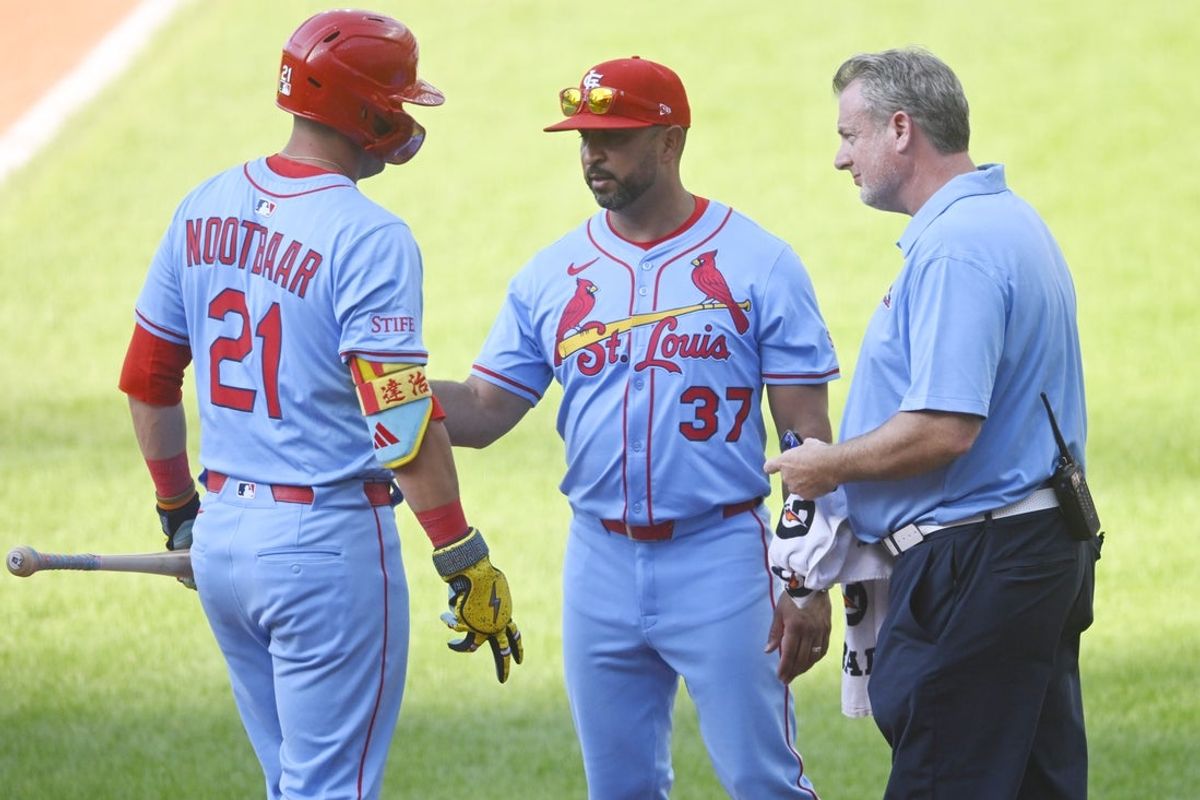 Jun 28, 2025; Cleveland, Ohio, USA; St. Louis Cardinals manager Oliver Marmol (37) (right) and assistant athletic trainer Chris Conroy talk to left fielder Lars Nootbaar (21)(left) after he was hit by a foul ball in the ninth inning against the Cleveland Guardians at Progressive Field. Mandatory Credit: David Richard-Imagn Images