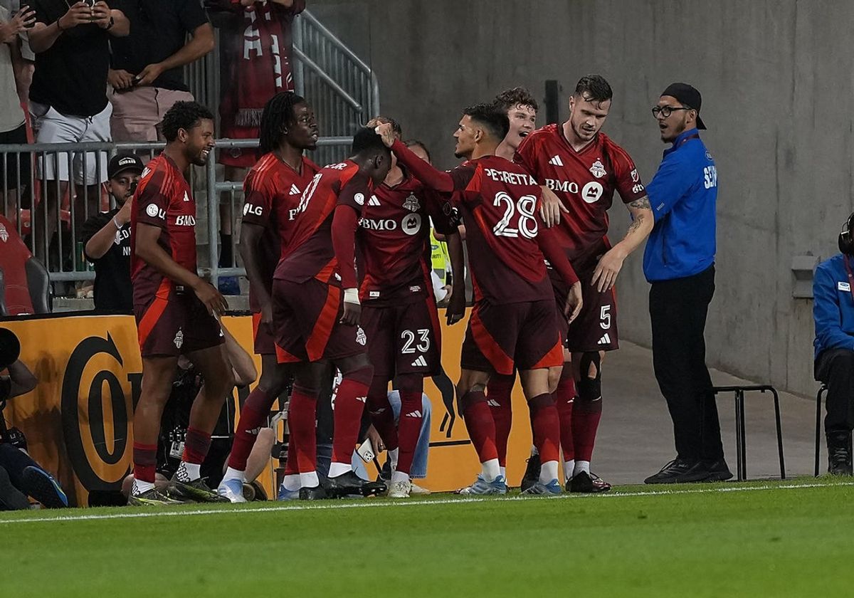 Jun 28, 2025; Toronto, Ontario, CAN; Toronto FC midfielder Derrick Etienne (11) celebrates an own goal with defender Raoul Petretta (28) against the Portland Timbers during the second half at BMO Field. Mandatory Credit: Nick Turchiaro-Imagn Images