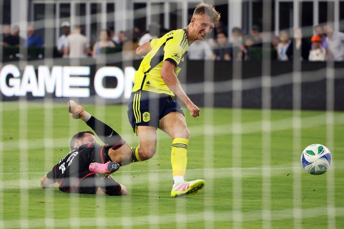 fJun 28, 2025; Washington, District of Columbia, USA; Nashville SC forward Sam Surridge (9) takes a shot on goal past D.C. United defender Conner Antley (12) during the first half at Audi Field. Mandatory Credit: Daniel Kucin Jr.-Imagn Images