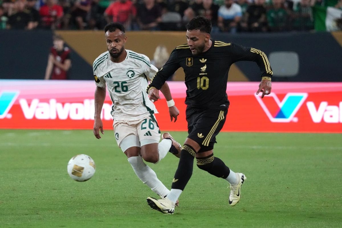 Jun 28, 2025; Glendale, Arizona, USA; Saudi Arabia defender Ali Majrashi (26) and Mexico forward Alexis Vega (10) battle for the ball in the second half during a quarterfinal match of the 2025 Gold Cup at State Farm Stadium. Mandatory Credit: Rick Scuteri-Imagn Images