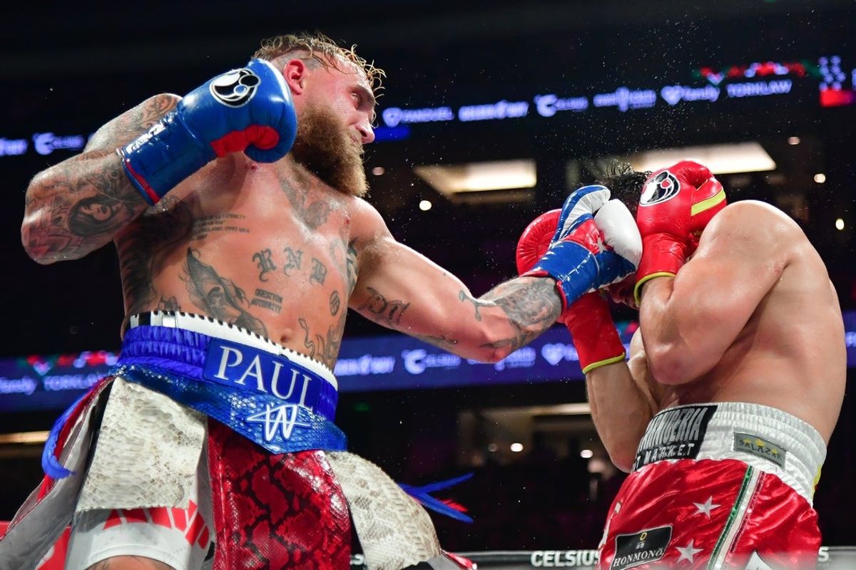 Jun 28, 2025; Anaheim, California, USA;  Jake Paul moves in for a hit against Julio Cesar Chavez Jr. at Honda Center. Mandatory Credit: Gary A. Vasquez-Imagn Images