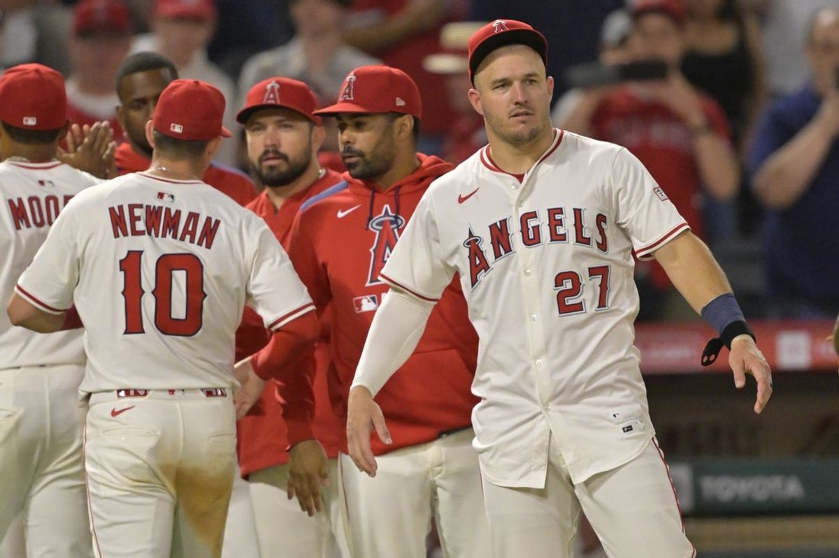 Jun 28, 2025; Anaheim, California, USA;  Los Angeles Angels right fielder Mike Trout (27) greets third baseman Kevin Newman (10) after the final out of the ninth inning defeating the Washington Nationals at Angel Stadium. Mandatory Credit: Jayne Kamin-Oncea-Imagn Images